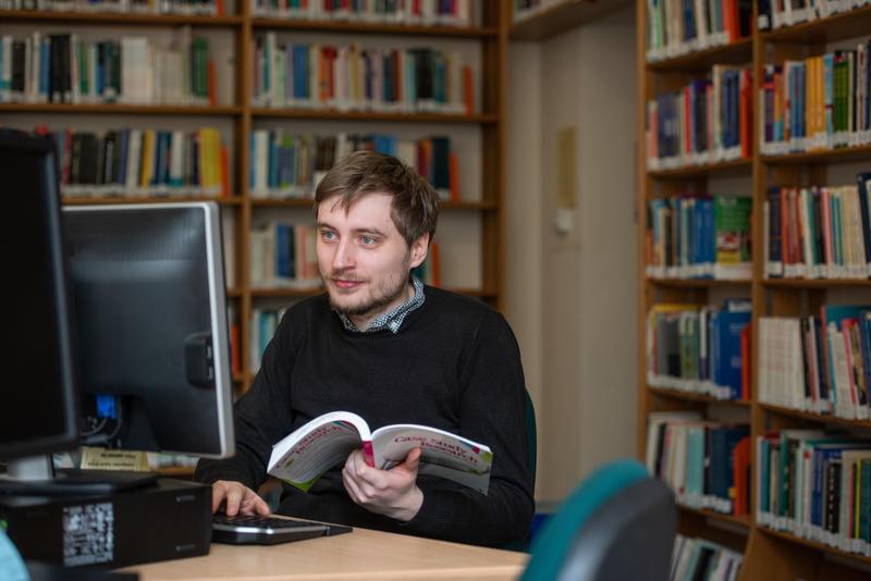 Researcher at a computer in the library