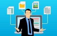Cartoon image of a person in front of a monitor with four different types of data (spreadsheet, image, docs etc) feeding in.