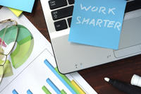 Sticky note on a laptop saying  'work smarter'